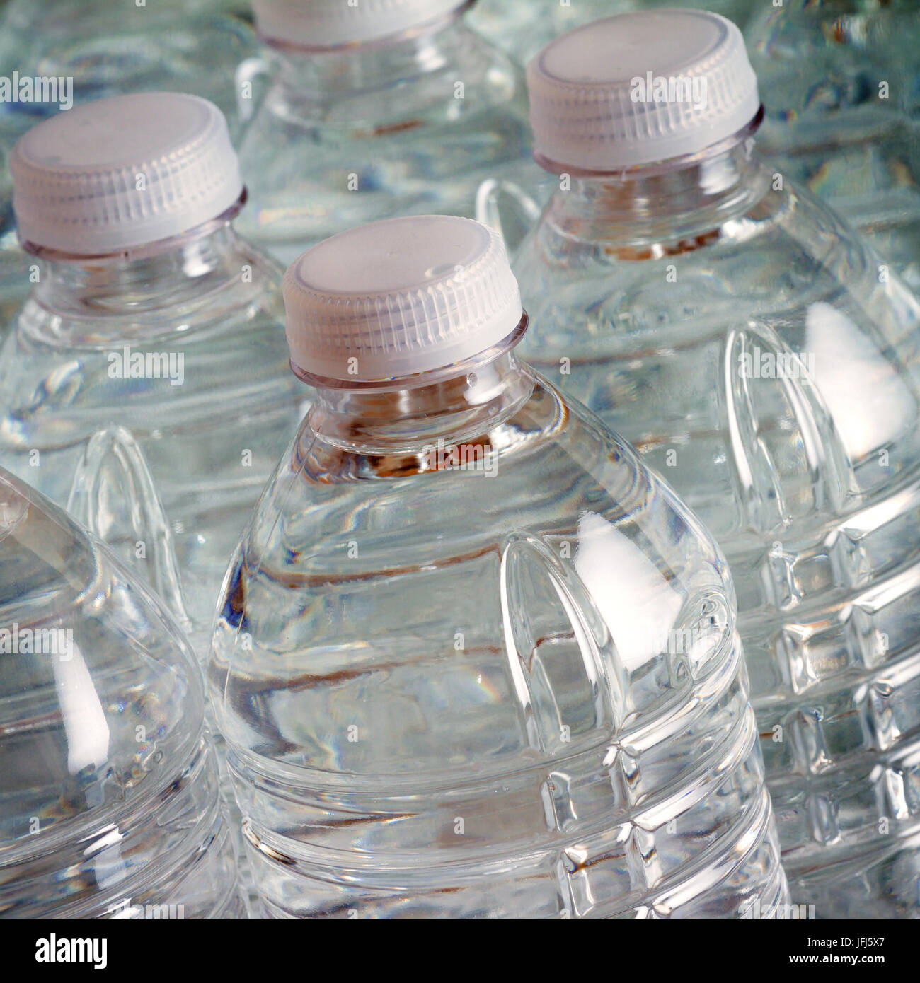 Transparent drinking water bottles with white caps Stock Photo - Alamy
