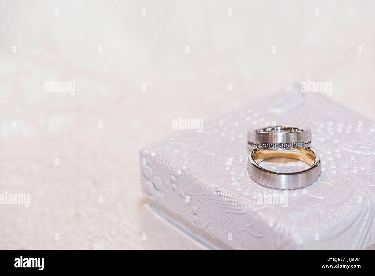 Wedding rings made of gold and platinum with diamonds on white precious