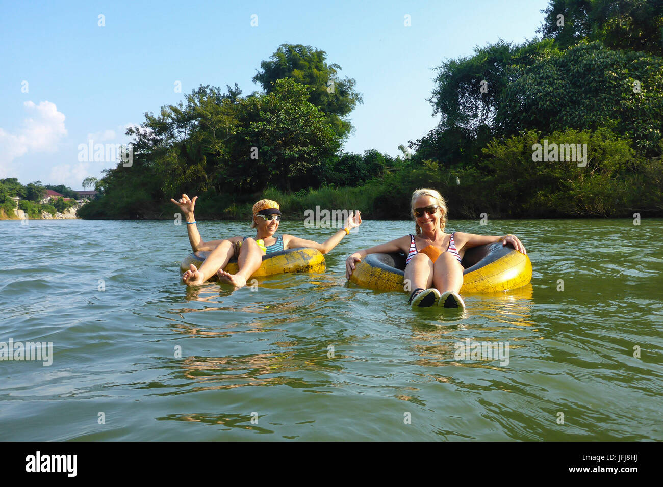 Asia, Laos, landlocked country, South-East Asia, Indo-Chinese peninsula, Nam Xong river, Vang Vieng, leisure time on the river, two tourists, Tubing in Vang Vieng Stock Photo