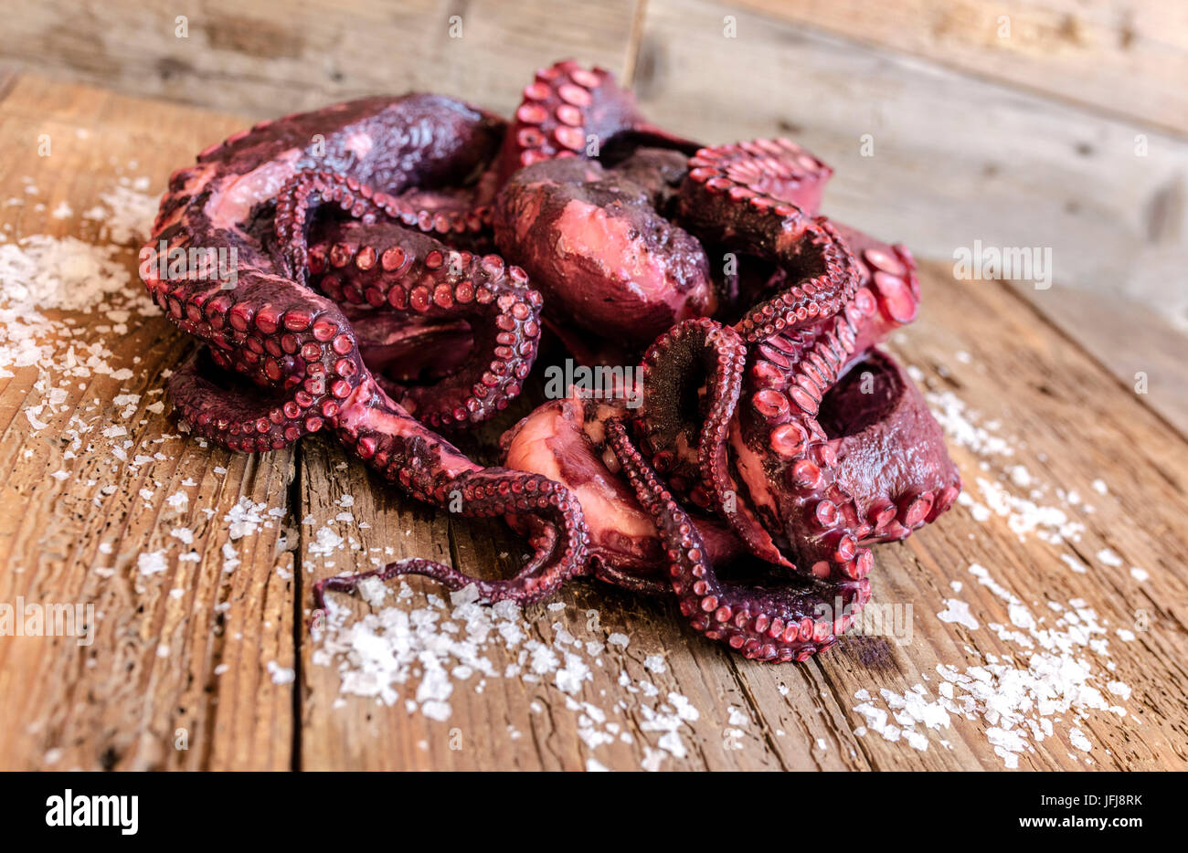 Fresh octopus on chopping board a typical ingredient of the healthy Italian cuisine Stock Photo