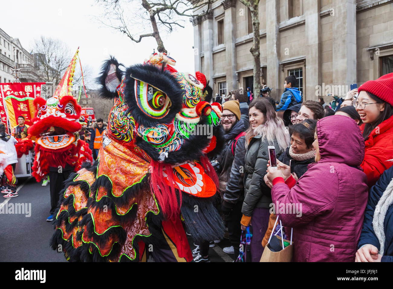 England, London, Chinese New Year Parade, Child Wearing Chinese Lion Mask Stock Photo