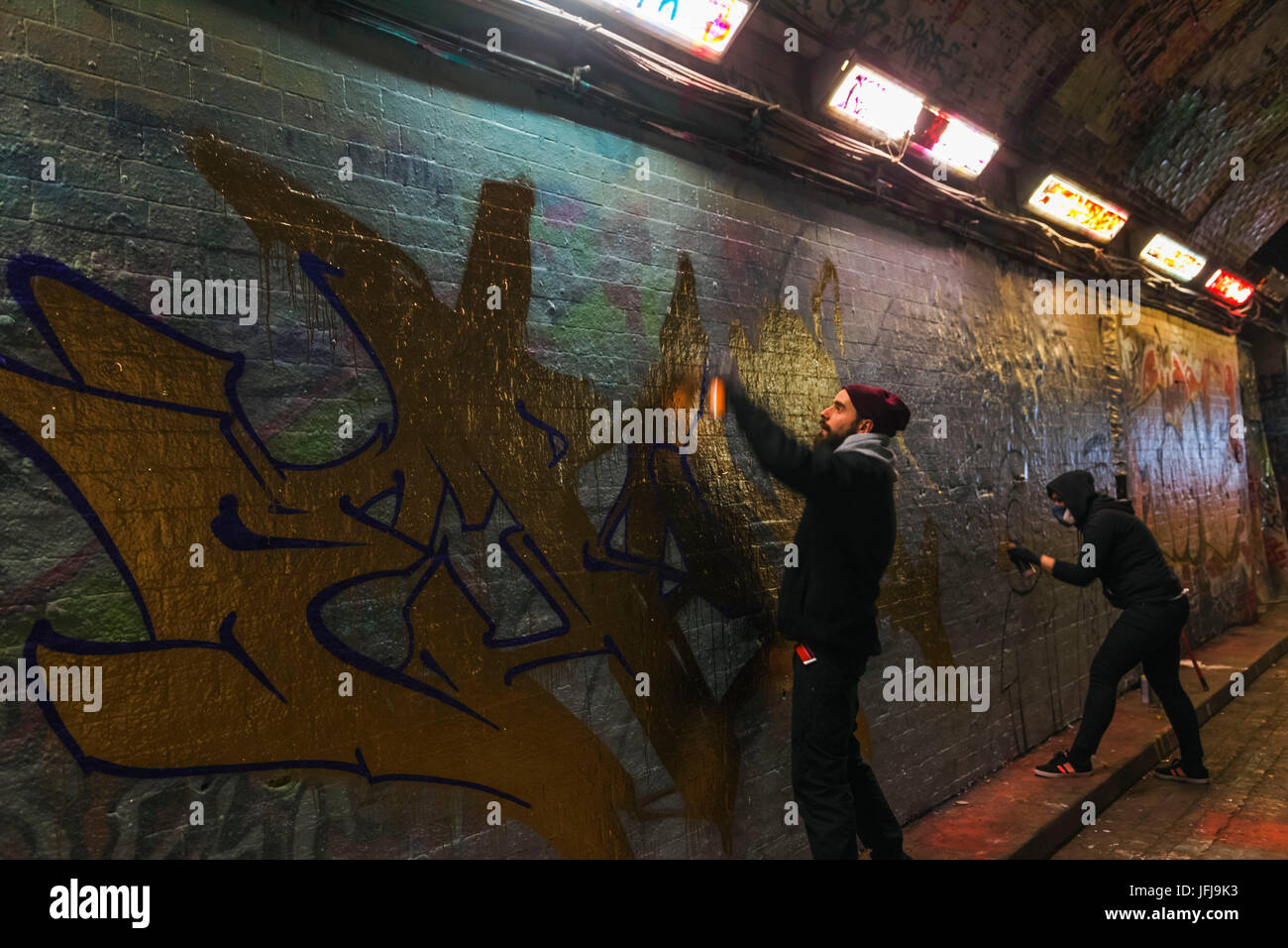 England, London, Lambeth, Waterloo, Leake Street, Graffiti and Wall Art Tunnel, Graffiti Artists at Work Stock Photo
