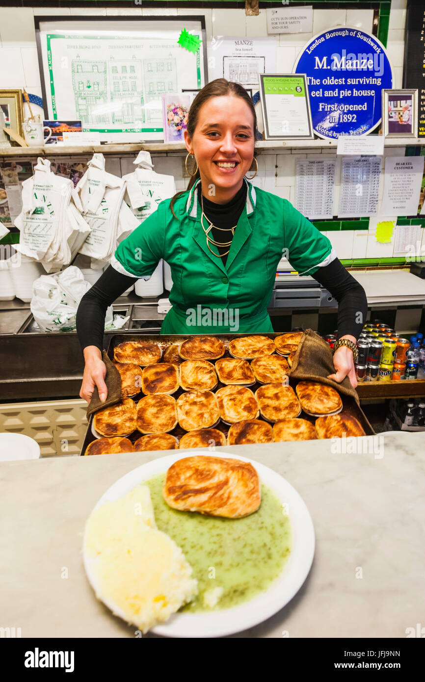 England, London, Southwark, Manze Pie and Mash Shop, Assistant Holding Tray of Pies Stock Photo