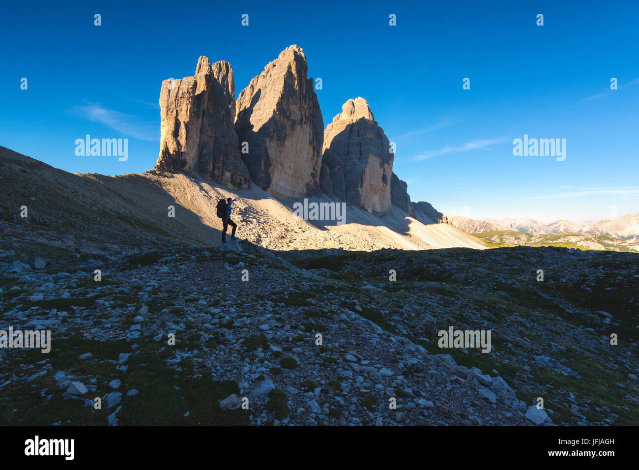 Hiker and the three peaks of Lavaredo, Bolzano province, Trentino Alto Adige, Italy, Stock Photo