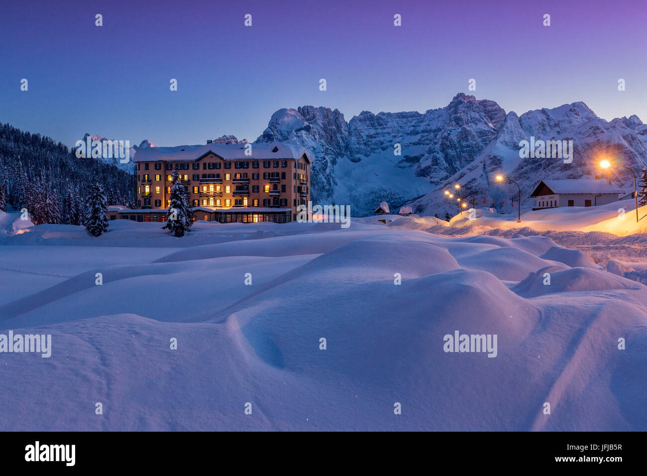 An health institution on Misurina's lake in wintertime's sunset, with peaks in the background, Auronzo di Cadore, Belluno, Dolomites, Italy Stock Photo