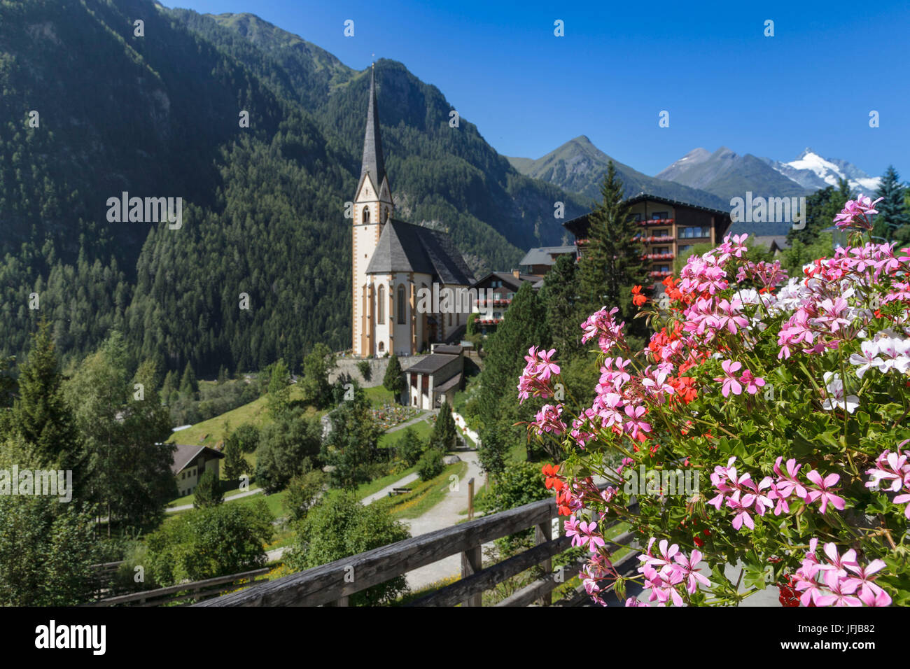 Europe, Austria, Carinthia, district of Spittal an der Drau, Heiligenblut with St Vincent Church and Grossglockner mountain on background Stock Photo