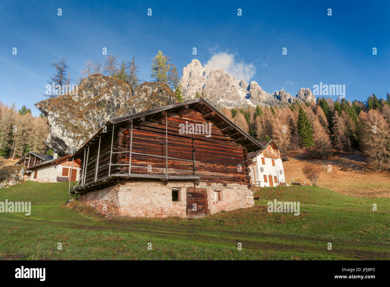 Europe, Italy, Trentino, Primiero, Typical alpine huts in Fosne with mount Cimerlo in the background, Dolomites Stock Photo