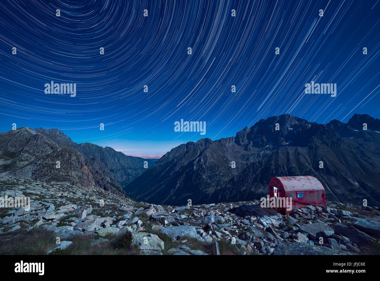 Italy, Piedmont, Cuneo District, Gesso Valley, Alpi Marittime Natural Park, Startrail over the bivouac Guiglia and Argentera Peak Stock Photo