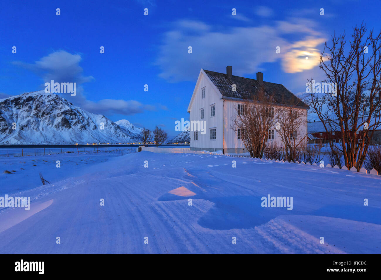 Typical house surrounded by snow in a cold winter day at dusk, Flakstad Lofoten Islands Norway Europe Stock Photo