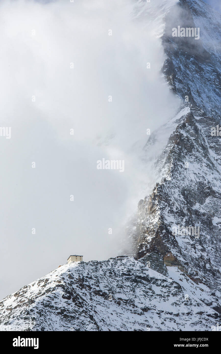 Hornli-hutte covered in the fog that hides the peak of the Matterhorn, Zermatt, Valais, Switzerland Europe Stock Photo