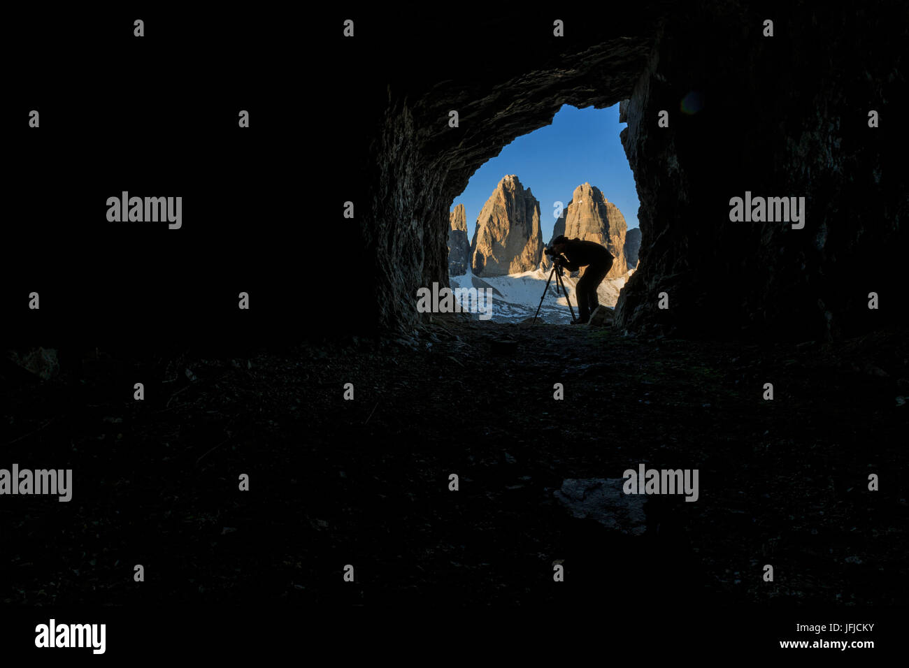 The photographer chose a cave in front of the Three Peaks of Lavaredo for his shots, Sesto Dolomites Trentino Alto Adige Italy Stock Photo