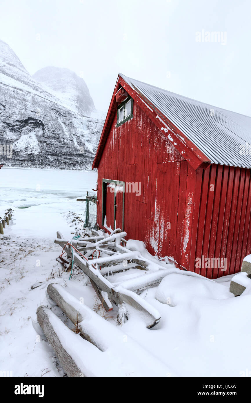 Typical Wooden Cabin In The Snowy Landscape Of Lyngseidet Lyngen