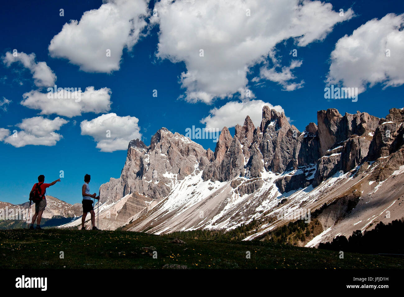 Hiker to Brogler Pass admire the group of Odle of Funes, Dolomites, Trentino Alto Adige, Italy Europe Stock Photo