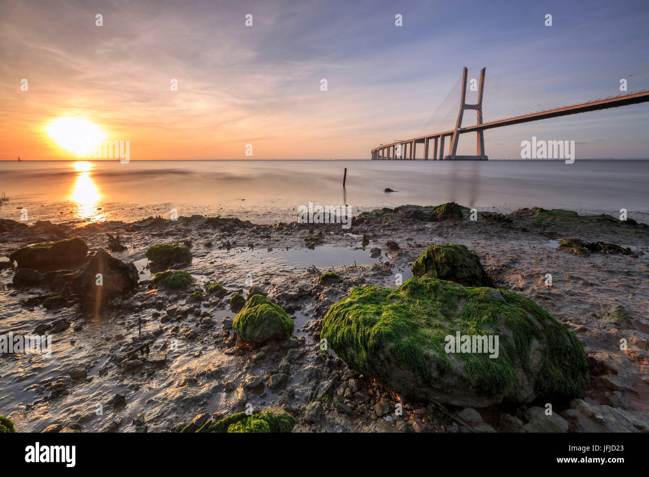 The sun rises on the Vasco da Gama Bridge that spans the Tagus River in Parque das Nações Lisbon Portugal Europe Stock Photo