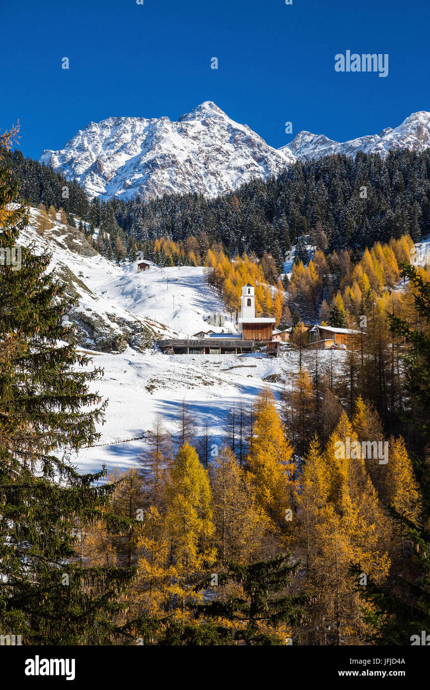 Snowy landscape and colorful trees in the small village of Sur Val Sursette Canton of Graubünden Switzerland Europe Stock Photo