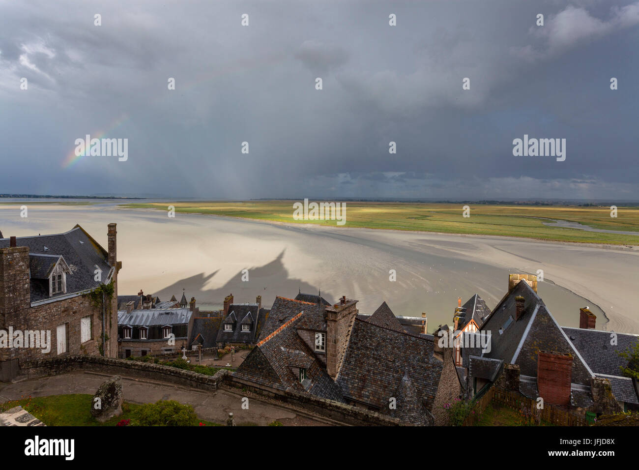 Mont Saint Michel, Normandy, France, A view of bay with rainbow and abbey's shadow Stock Photo