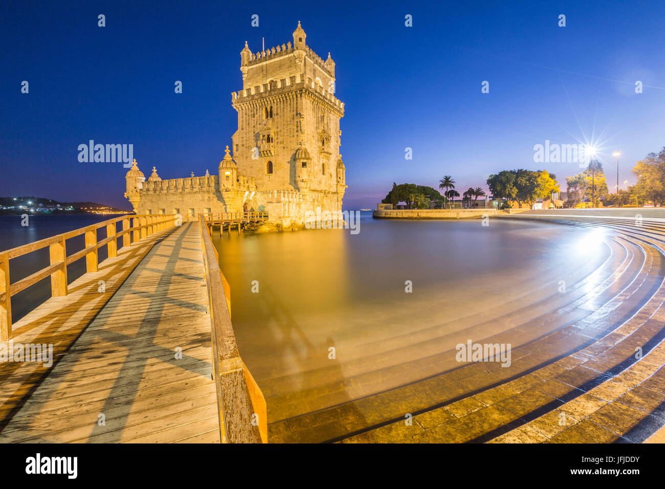 Blue dusk and lights on the Tower of Belém reflected in Tagus River Padrão dos Descobrimentos Lisbon Portugal Europe Stock Photo