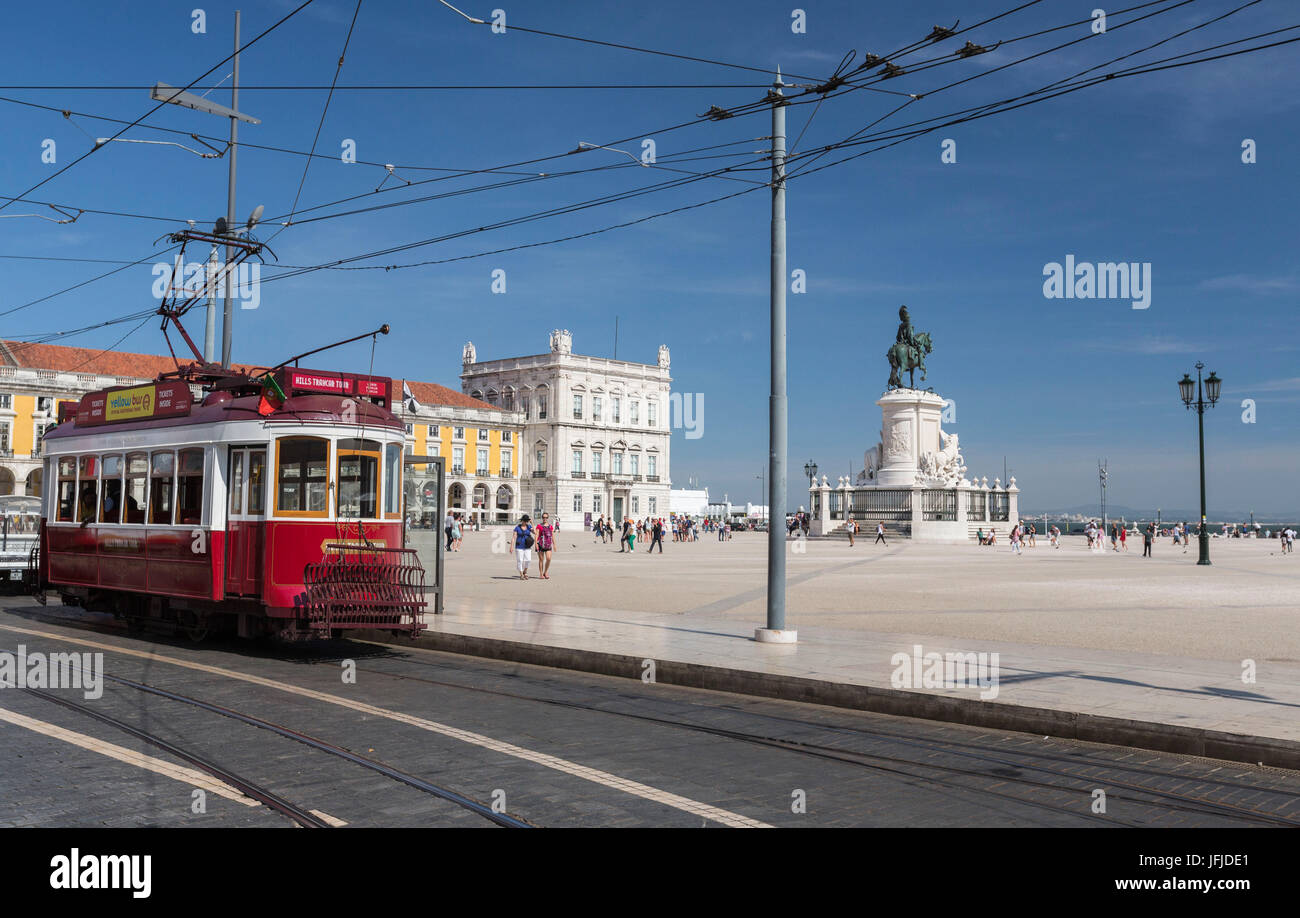 A typical red tram stops at the historical Praca Do Comercio square near the Tagus river Lisbon Estremadura Portugal Europe Stock Photo