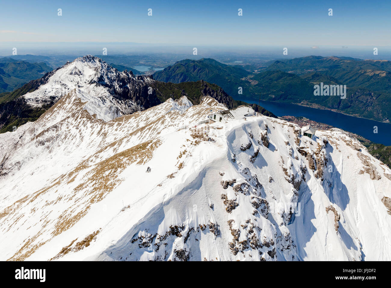 Aerial view of snowy peaks of Grignone with Brioschi Refuge on top and lake in background Lecco Province Lombardy Italy Europe Stock Photo