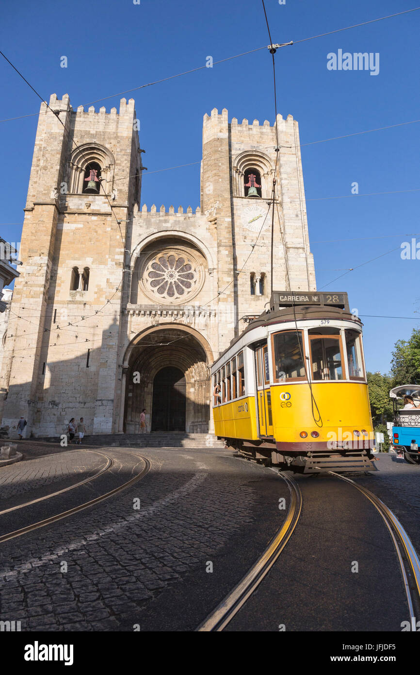 The yellow tram number 28 close to the ancient cathedral of Alfama district Lisbon Portugal Europe Stock Photo