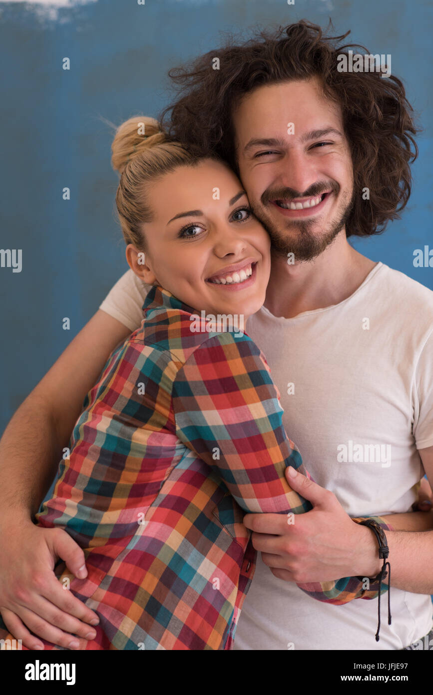 Portrait of a happy young smiling couple in love over color background ...