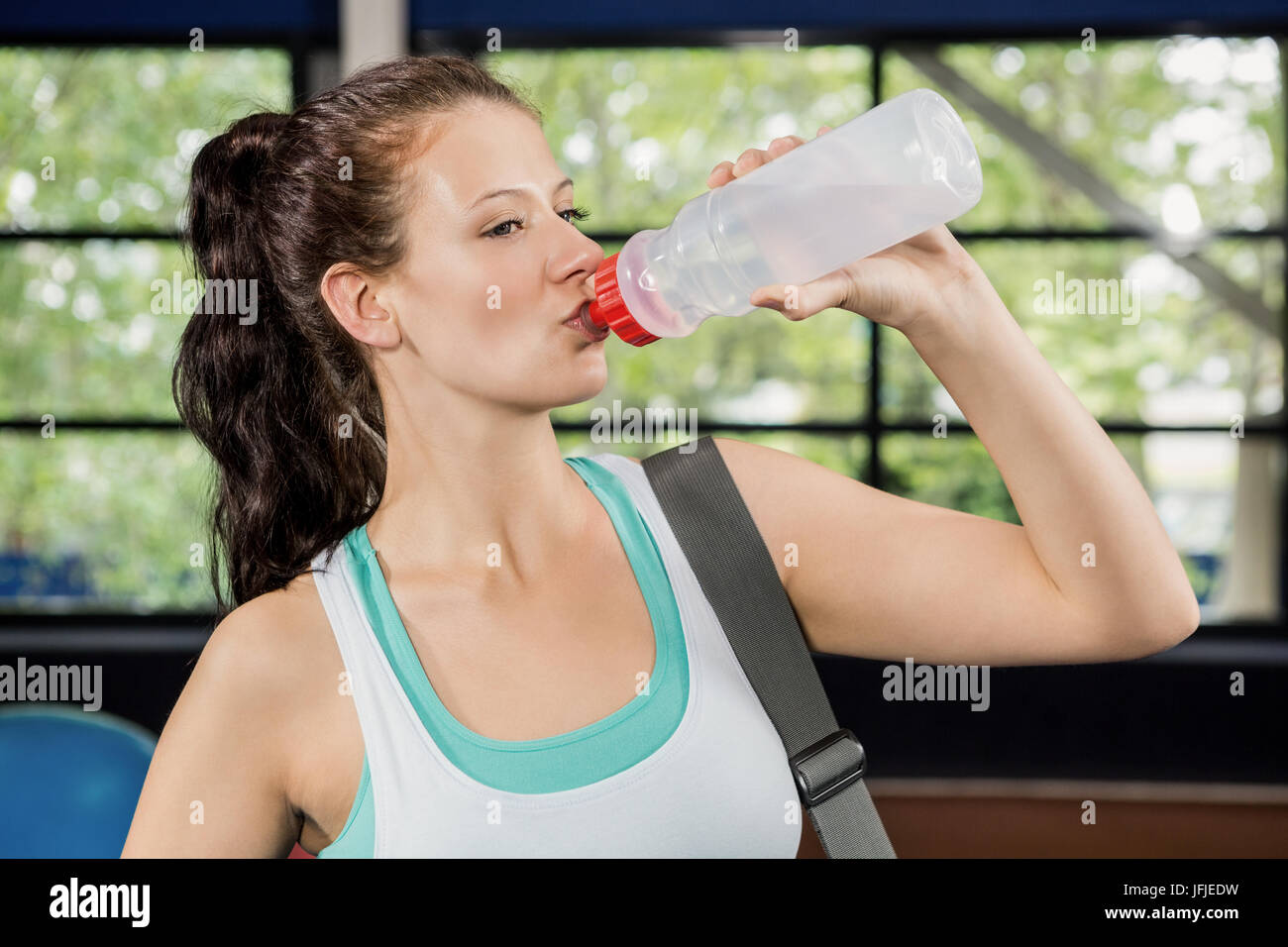 Woman drinking water after workout Stock Photo - Alamy