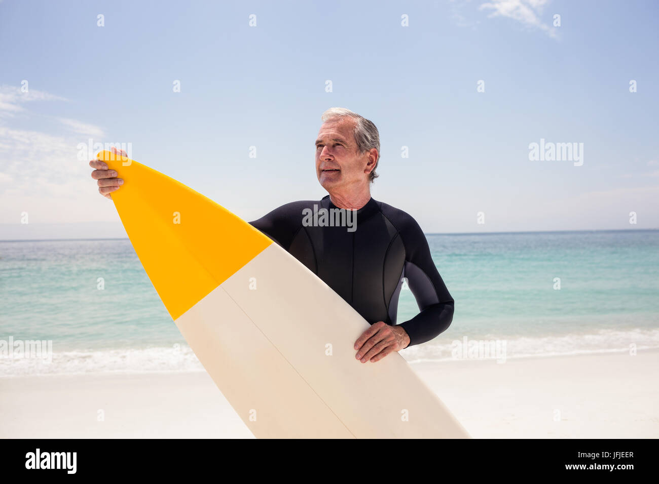 Senior surfer holding surfboard standing hi-res stock photography and ...
