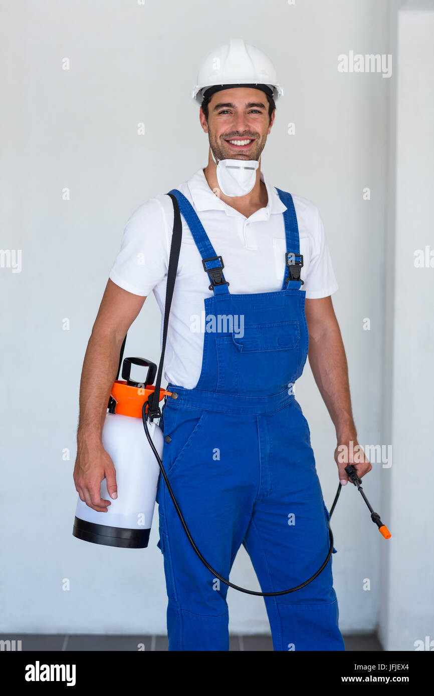 Portrait of happy manual worker with insecticide Stock Photo