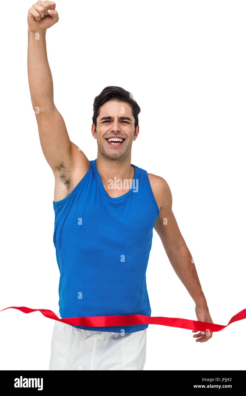 Portrait of cheerful winner athlete crossing finish line Stock Photo
