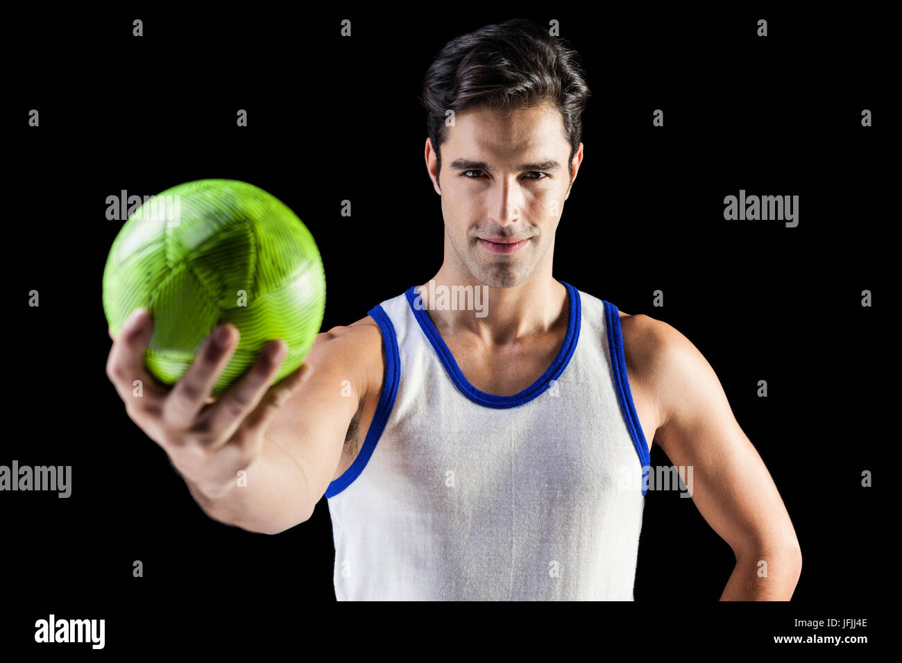 Portrait of happy male athlete holding a ball Stock Photo