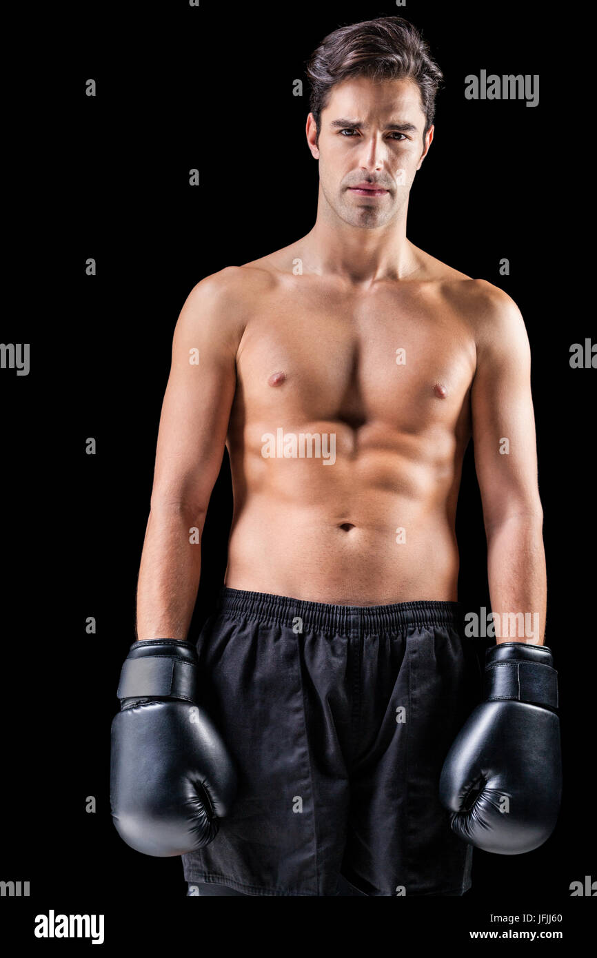 Portrait of boxer standing on black background Stock Photo