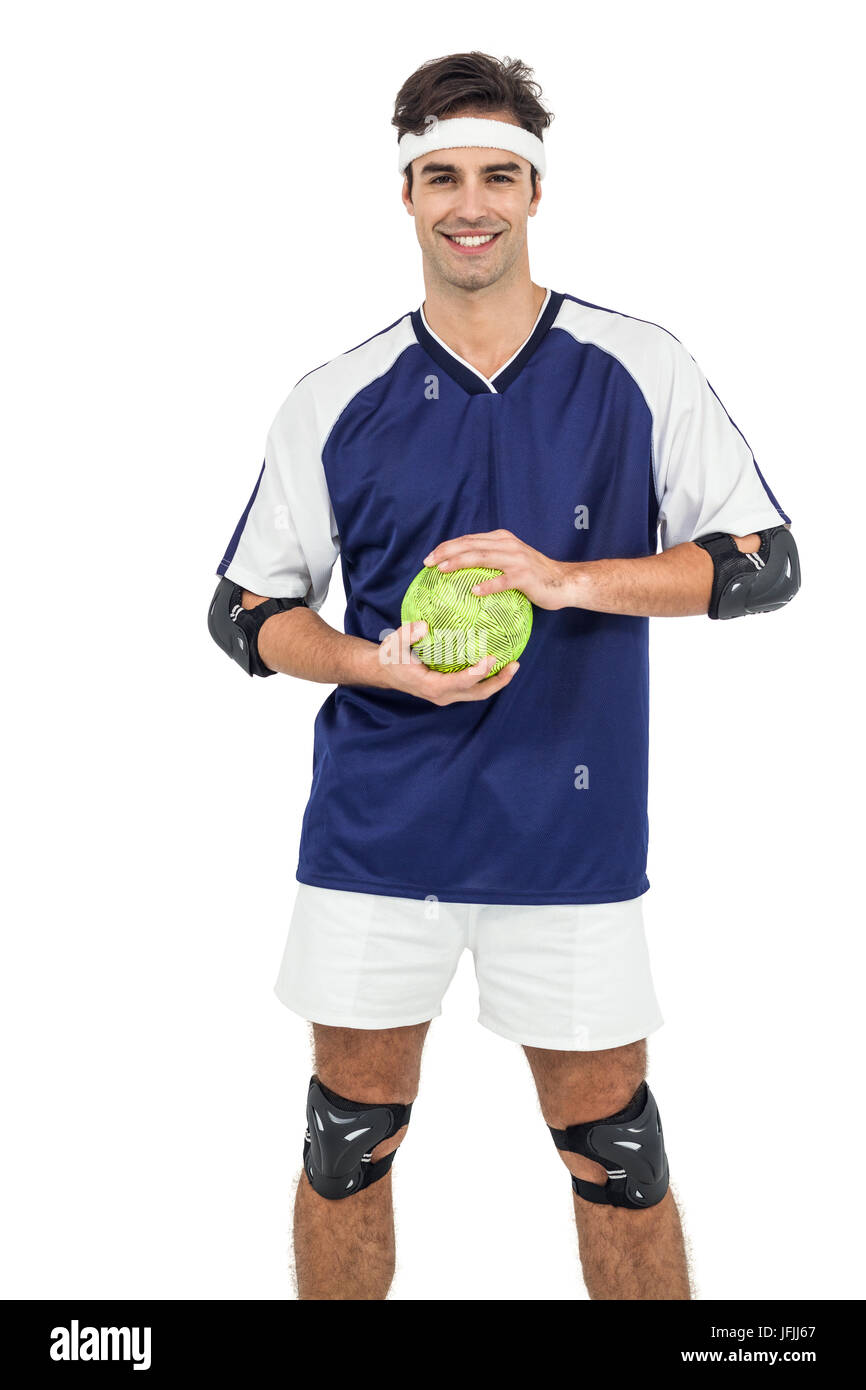 Sportsman standing with ball on white background Stock Photo