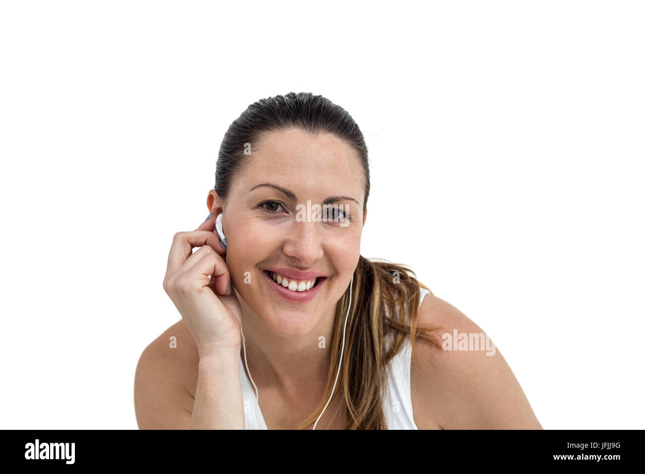 Athlete woman listening to music on headphone Stock Photo
