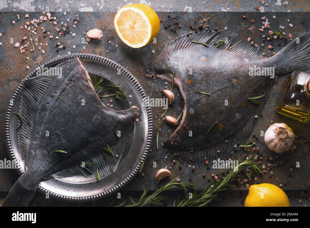 Raw flounders with different seasoning on the stone horizontal Stock Photo