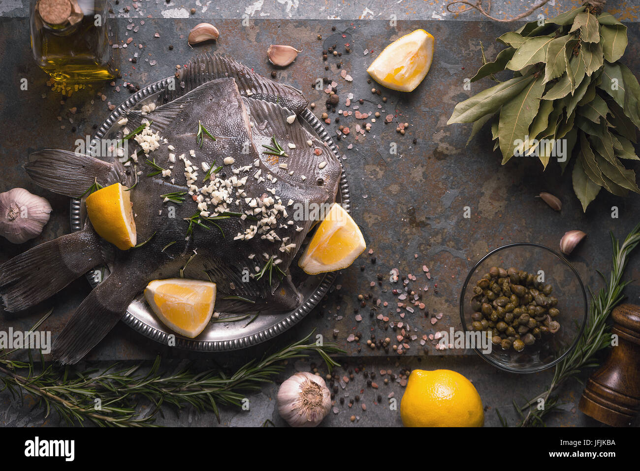 Raw flounders with different seasoning on the stone background top view horizontal Stock Photo