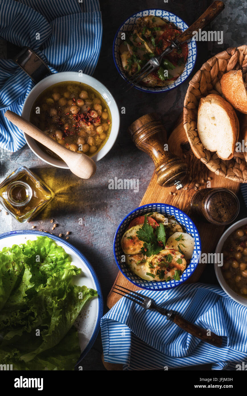 Chickpea soup  Revithia and vegetable stew Briam on the stone background top view vertical Stock Photo