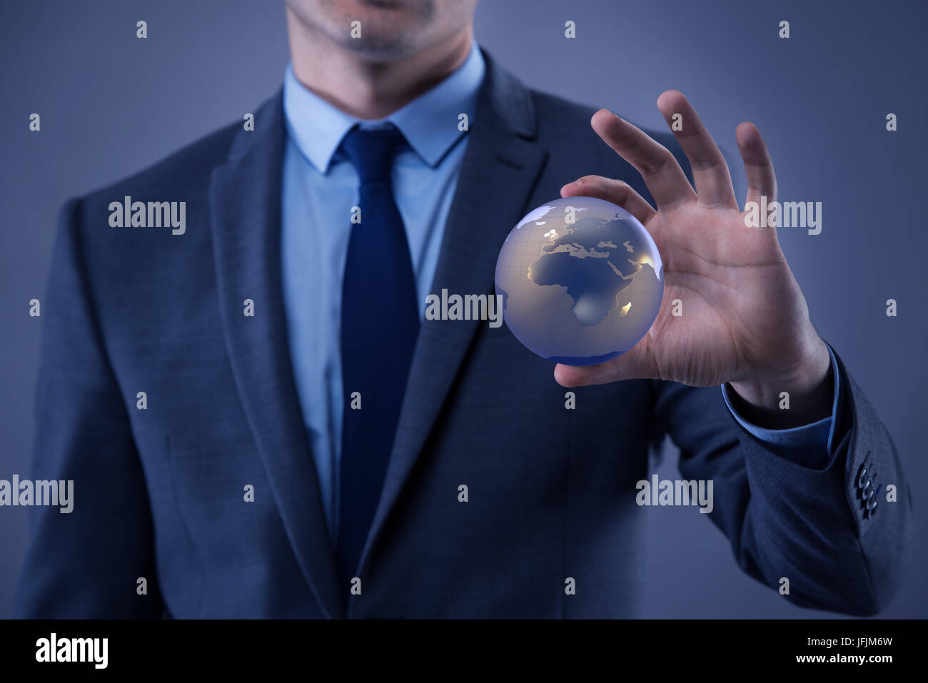 The businessman holding globe in global business concept Stock Photo ...
