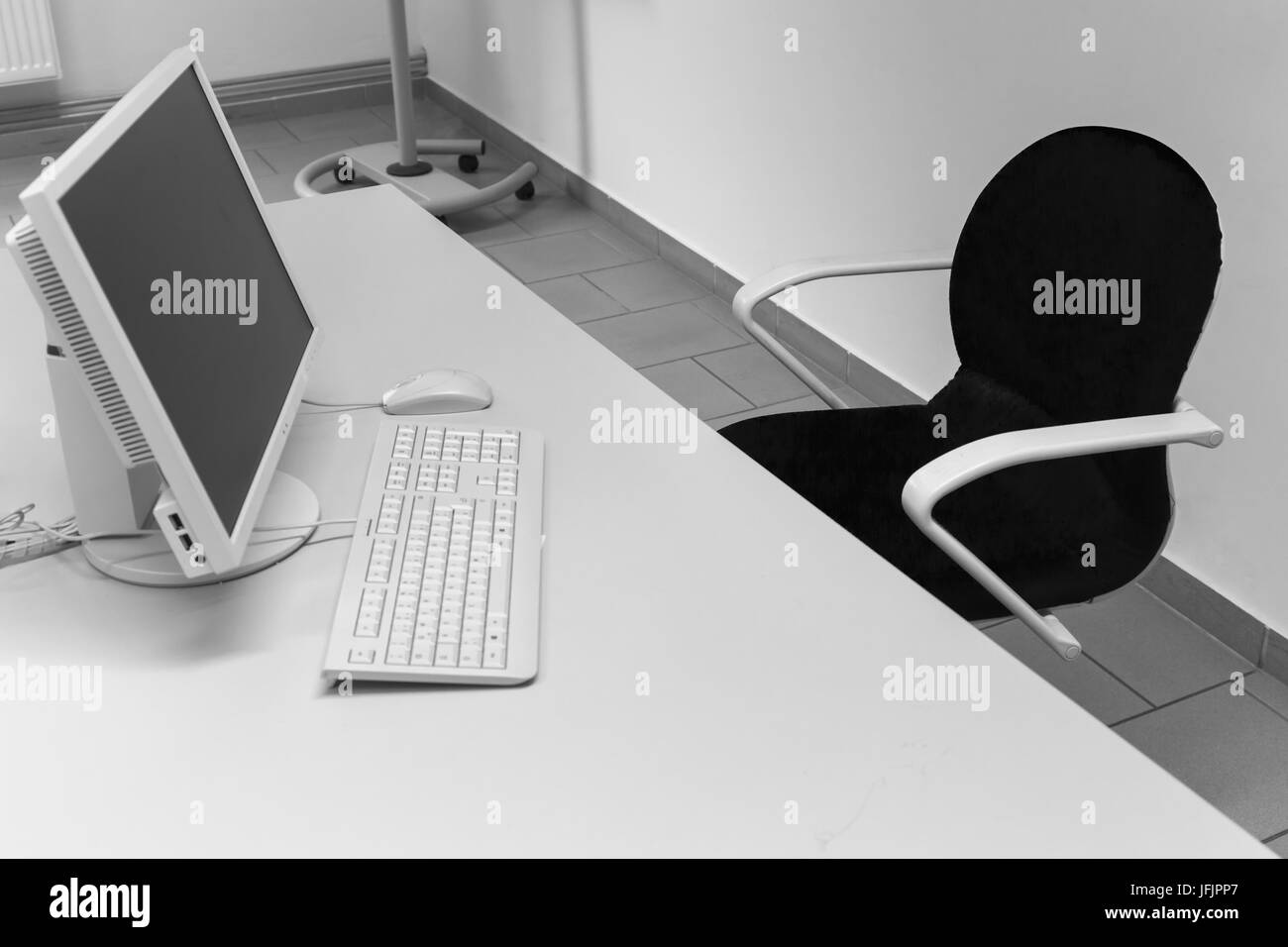 Desk with chair, PC monitor and keyboard Stock Photo Alamy