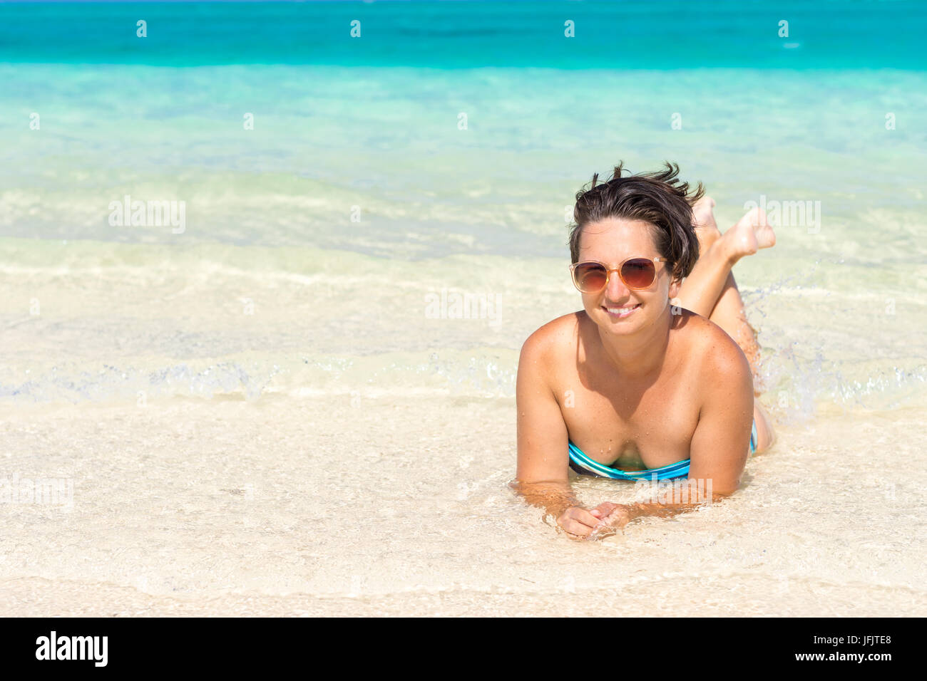 Mature woman enjoying herself on the beach Stock Photo - Alamy