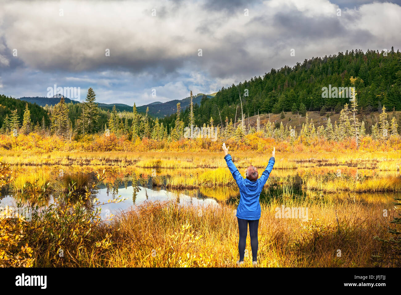 An elderly woman in awe of the beautiful nature Stock Photo