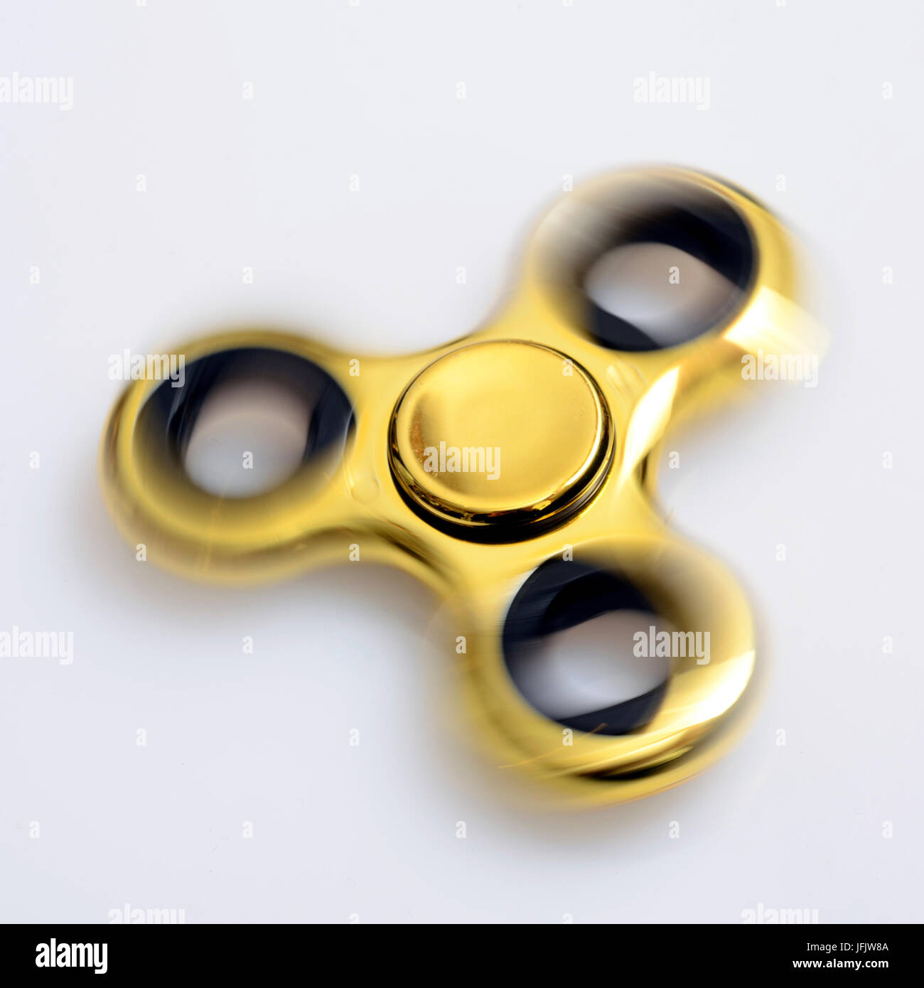 Hand holding fidget spinner golden toy Stock Photo by ©Premium_shots  152129290