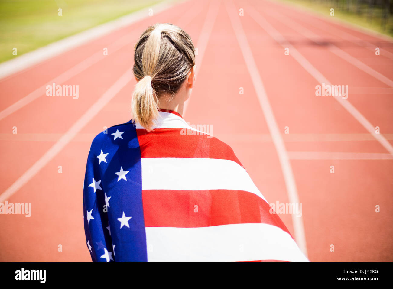 Rear view of female athlete wrapped in american flag Stock Photo - Alamy