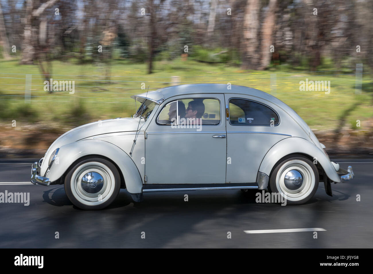 Vintage Volkswagen Beetle driving on country roads near the town of ...