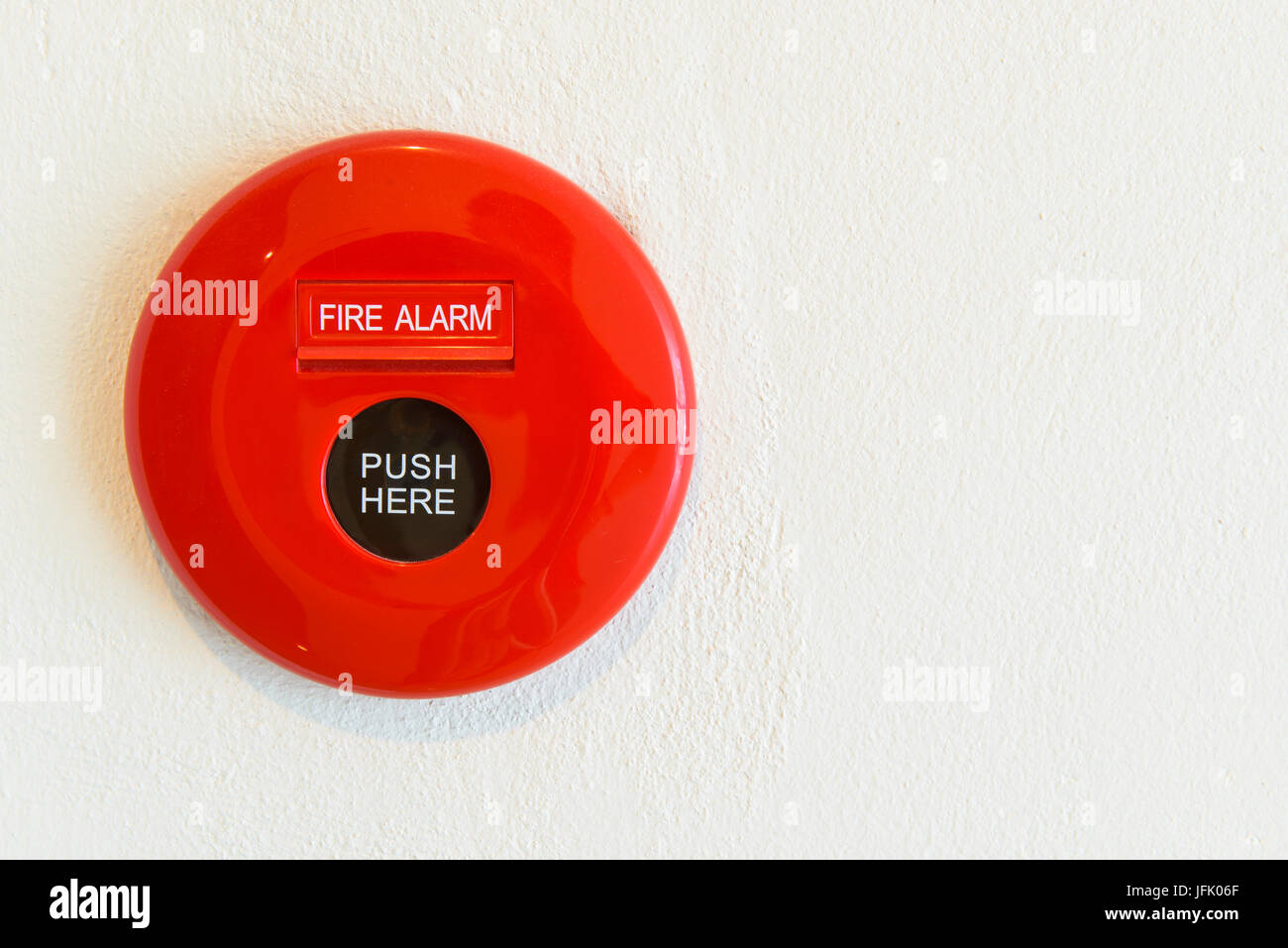 Red fire alarm on a wall Stock Photo