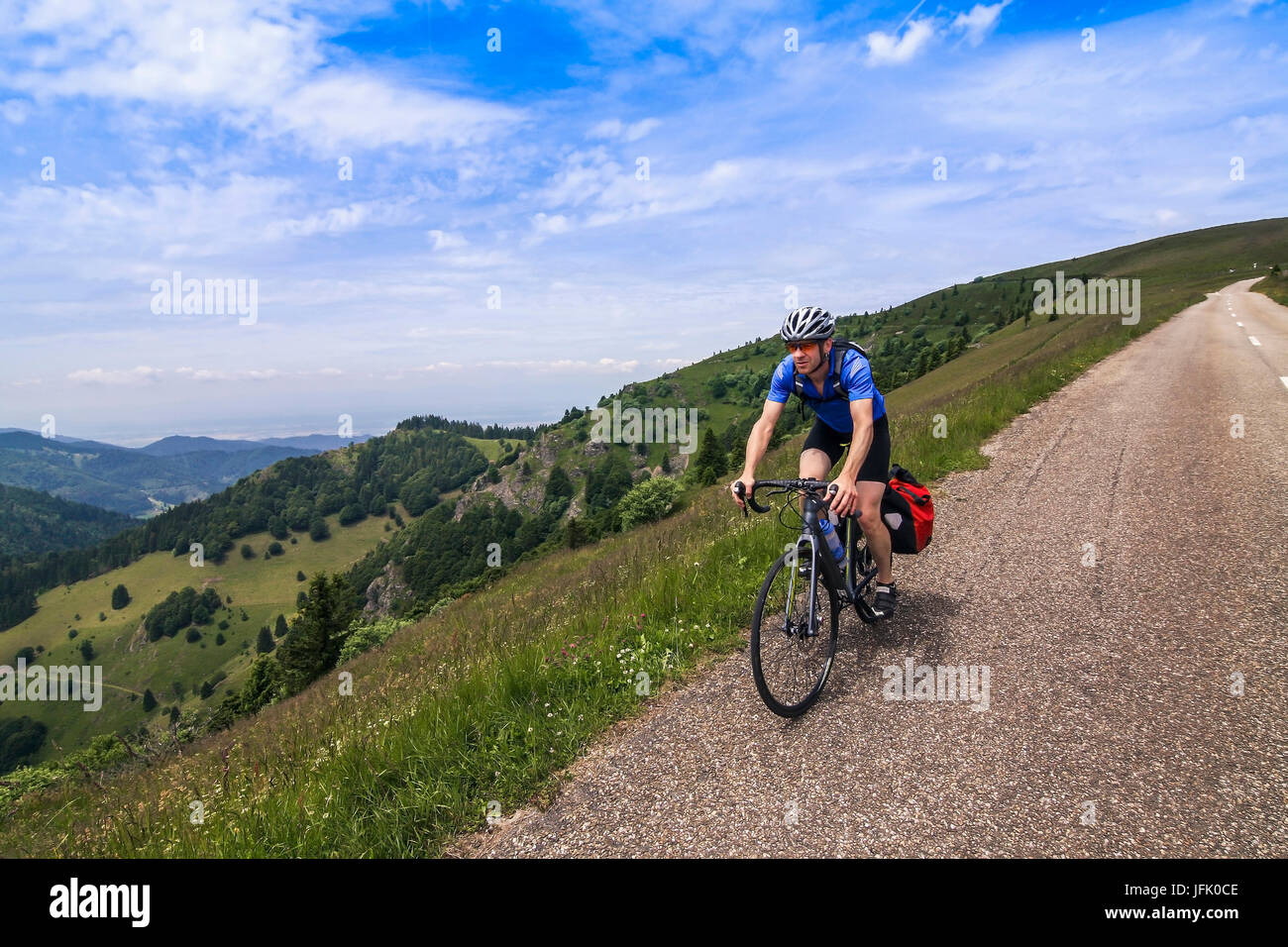 Mature man riding bike on hilly areas Stock Photo Alamy