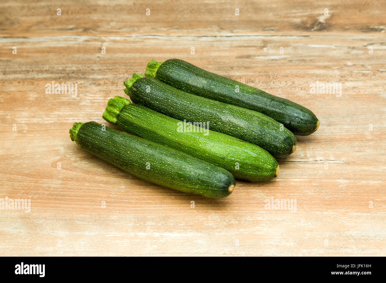 raw zucchini on wooden table Stock Photo