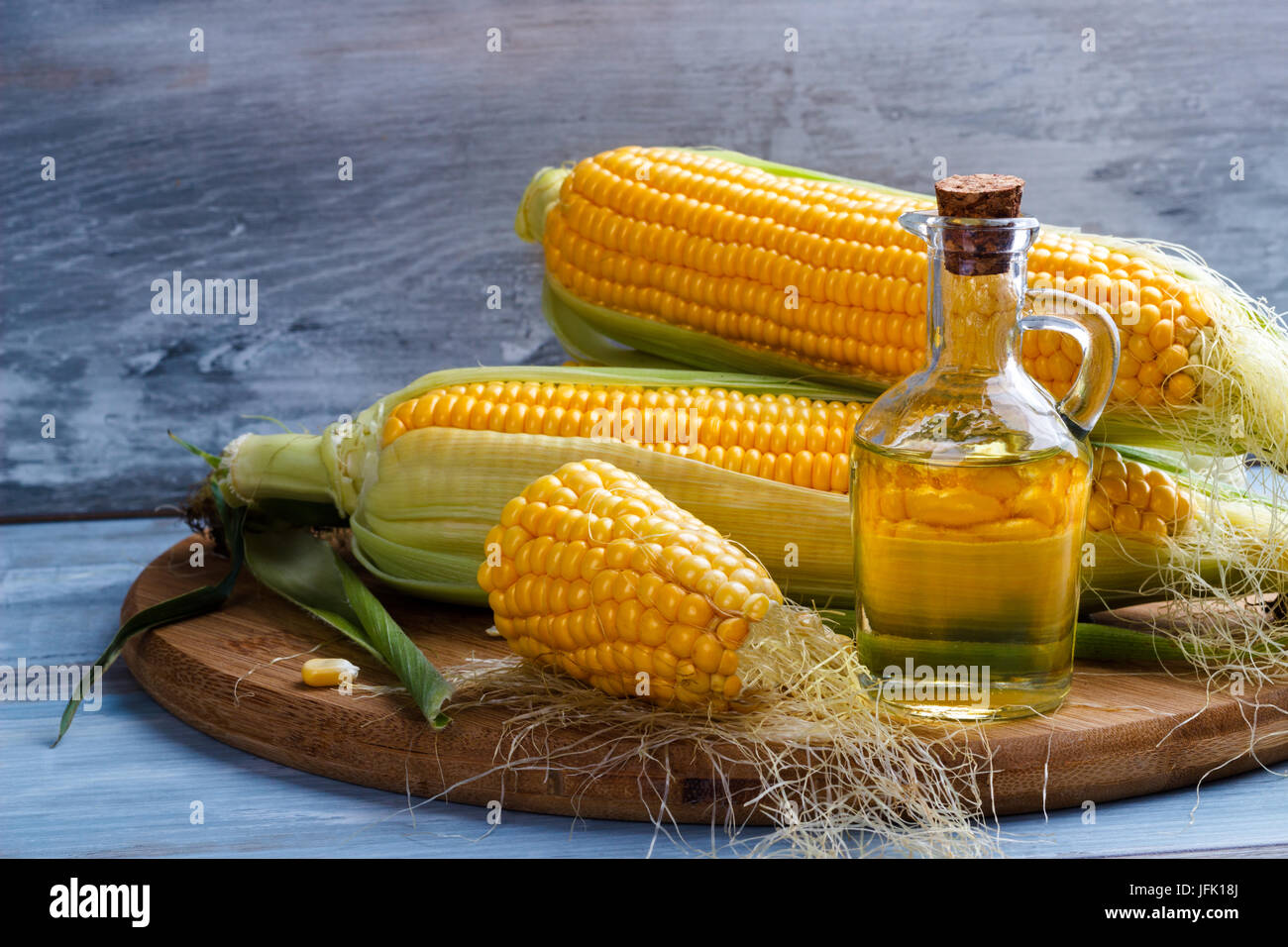 Fresh corn with bottle of oil Stock Photo
