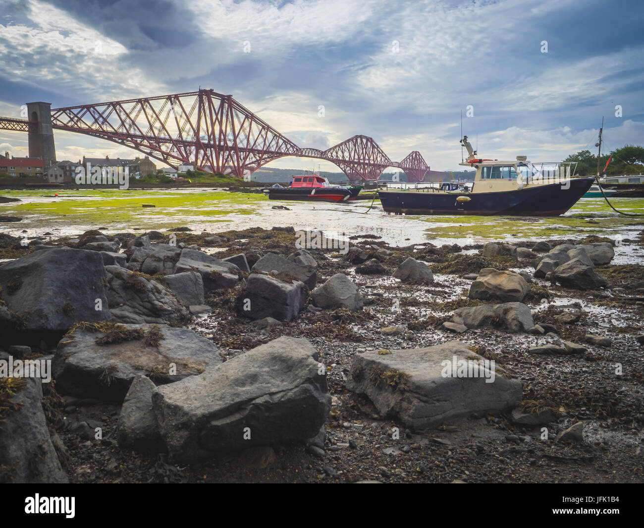 Boat moored in front of the Forth Rail Bridge Stock Photo