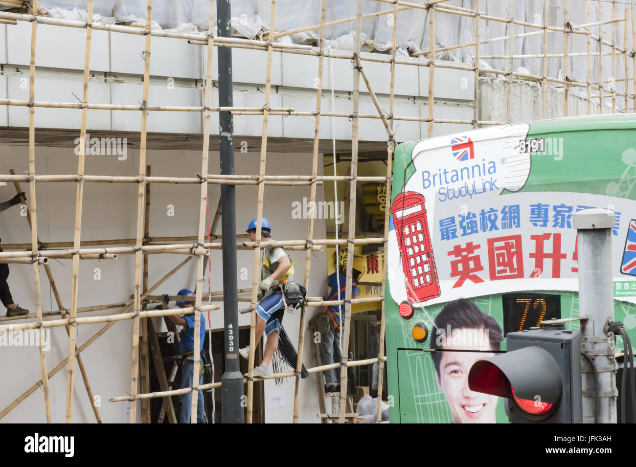 Construction workers build a wooden framework in downtown Hong Kong Stock Photo