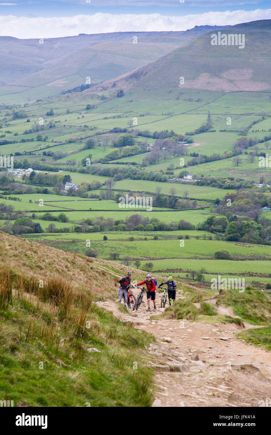 Mountain bikers climbing out of the Vale of Edale on to The Great Ridge, Peak District, Derbyshire, England, UK Stock Photo